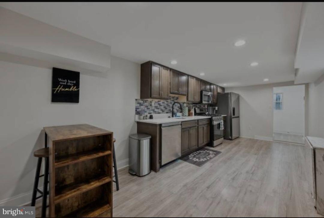 401 South Ann Street Baltimore, MD 21231 - Photo 22 of 30 a kitchen with a stove and cabinets
