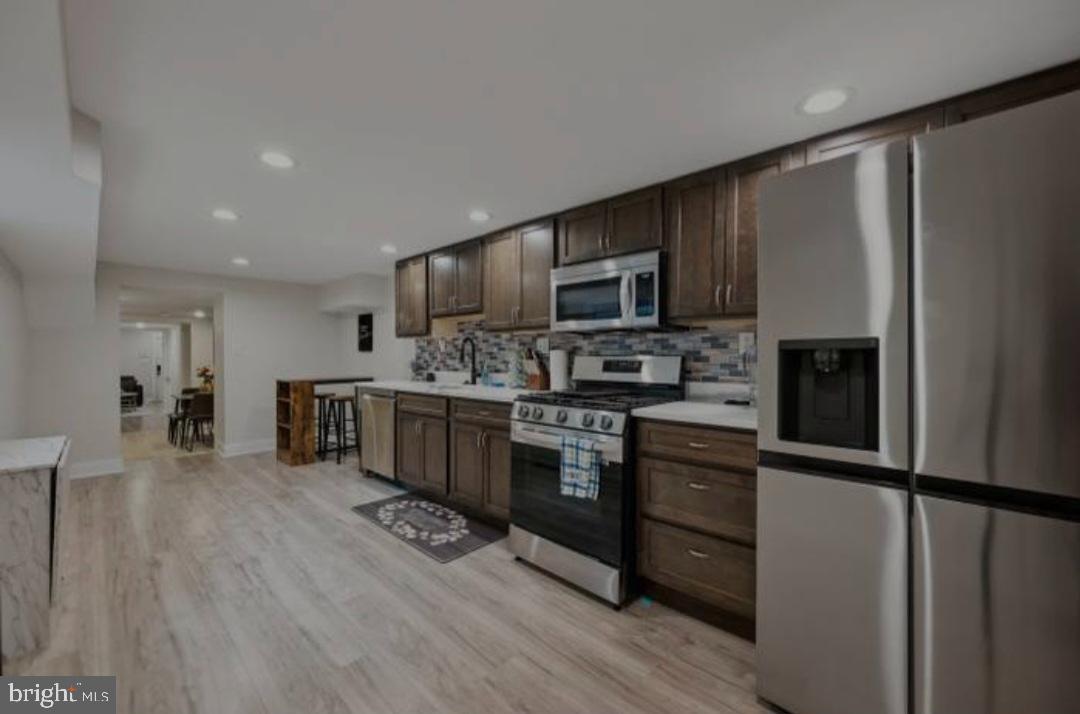 401 South Ann Street Baltimore, MD 21231 - Photo 23 of 30 a kitchen with stainless steel appliances a refrigerator sink and microwave