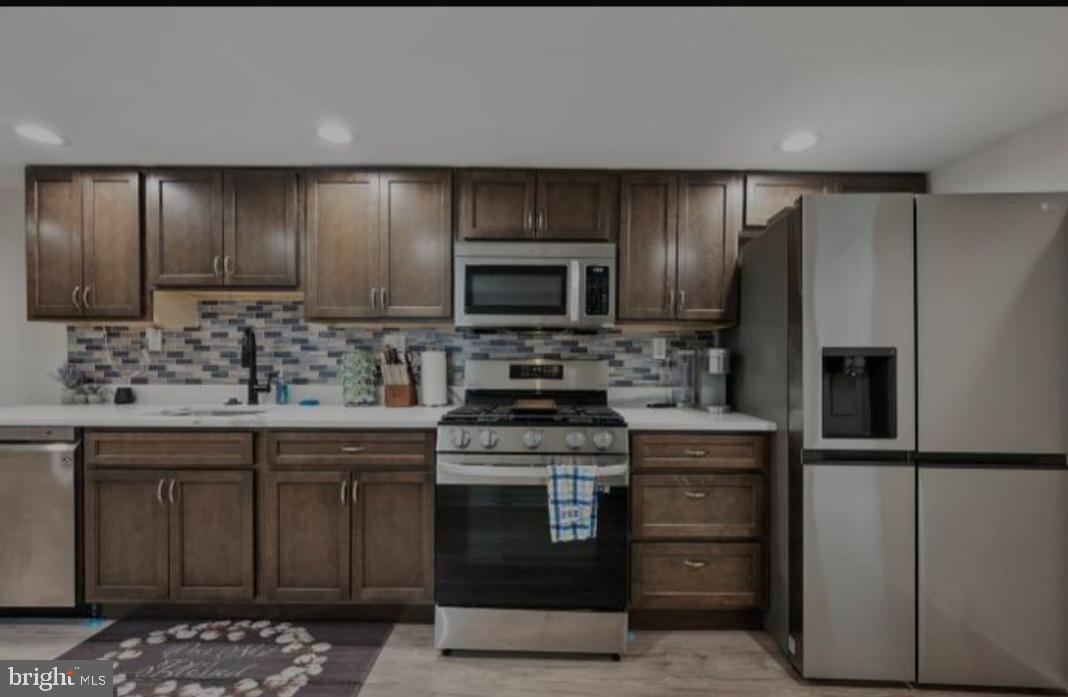 401 South Ann Street Baltimore, MD 21231 - Photo 24 of 30 a kitchen with a sink stove and refrigerator