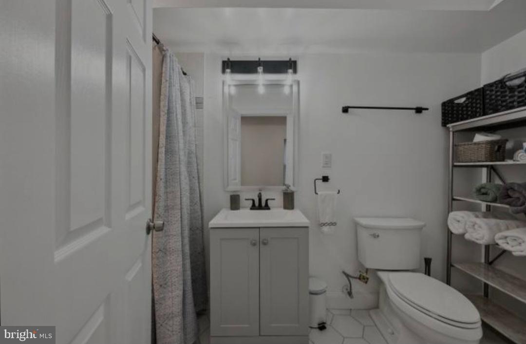 401 South Ann Street Baltimore, MD 21231 - Photo 29 of 30 a bathroom with a sink a toilet and shower