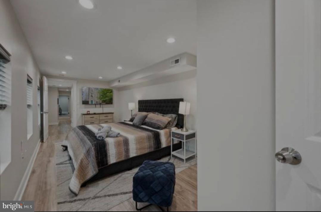 401 South Ann Street Baltimore, MD 21231 - Photo 7 of 30 a bedroom with a bed and a mirror