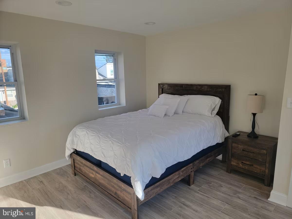 401 South Ann Street Baltimore, MD 21231 - Photo 10 of 30 a large bed sitting in a bedroom next to a window