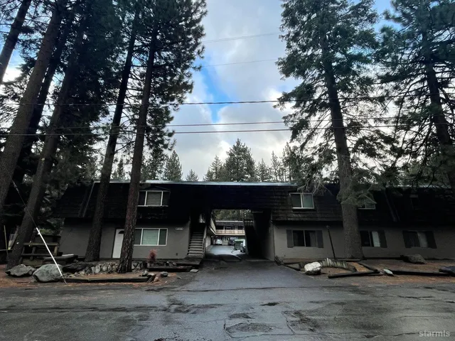 a view of a chairs and table in front of house