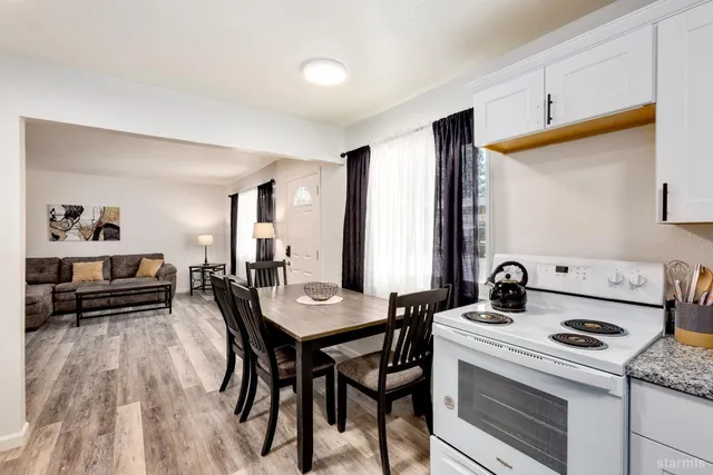 a view of a dining room with furniture and a kitchen