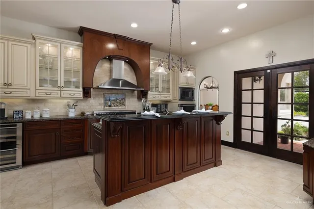 a kitchen with granite countertop stainless steel appliances stove and cabinets