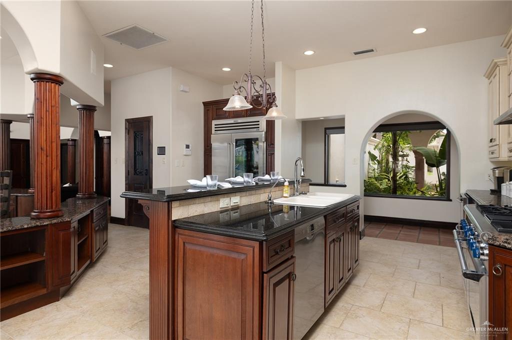3506 Oak Ridge Lane Mission, TX 78573 - Photo 18 of 45 a kitchen with kitchen island granite countertop a stove and a sink