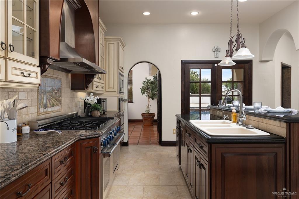 3506 Oak Ridge Lane Mission, TX 78573 - Photo 19 of 45 a kitchen with stove a sink and cabinets