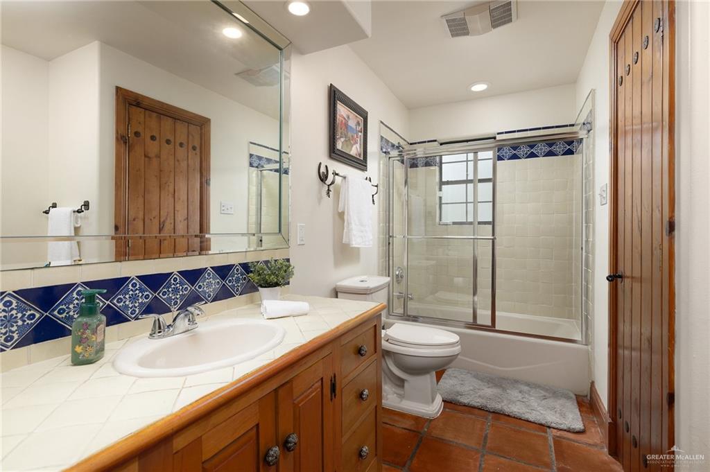 3506 Oak Ridge Lane Mission, TX 78573 - Photo 28 of 45 a bathroom with a granite countertop sink toilet and shower