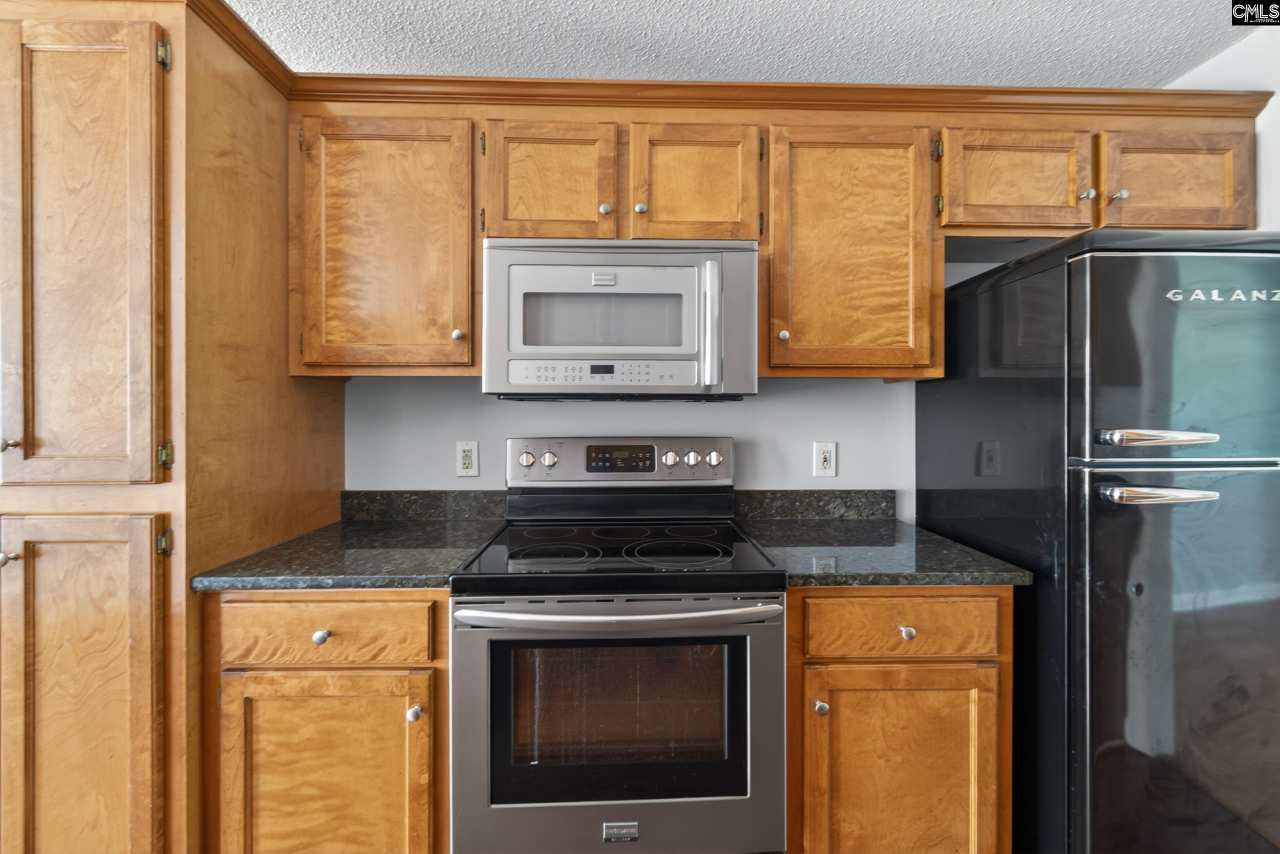 219 Plantation Pointe Drive Elgin, SC 29045 - Photo 39 of 56 a kitchen with granite countertop cabinets stainless steel appliances and a window