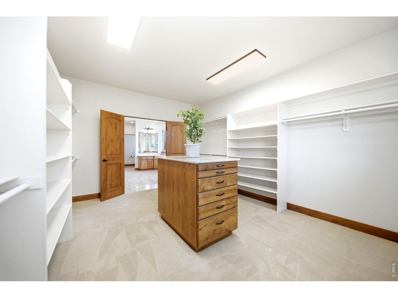 2153 Mountain River Road Berthoud, CO 80513 - Photo 22 of 50 Massive walk-in closet with a center island and custom shelving