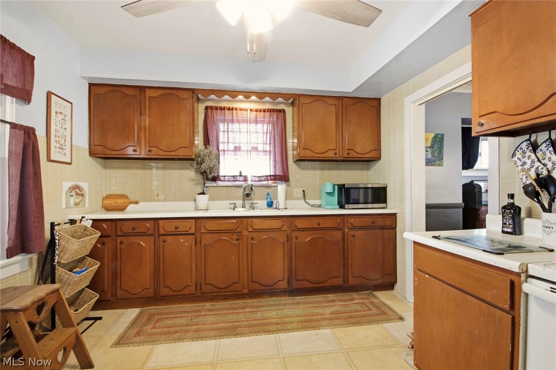 32 Como Street Struthers, OH 44471 - Photo 10 of 22 Kitchen with light countertops, wood finish cabinets, and ceiling fan