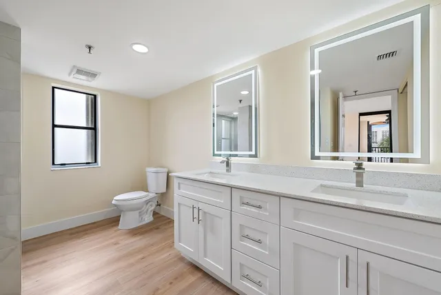 a white bath tub sitting next to a shower