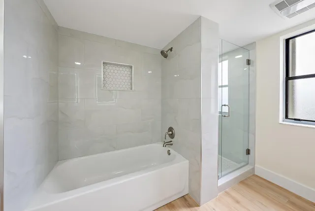 a view of empty room with wooden floor