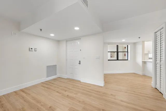wooden floor in an empty room with a window
