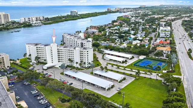 an aerial view of a house with a garden and lake view