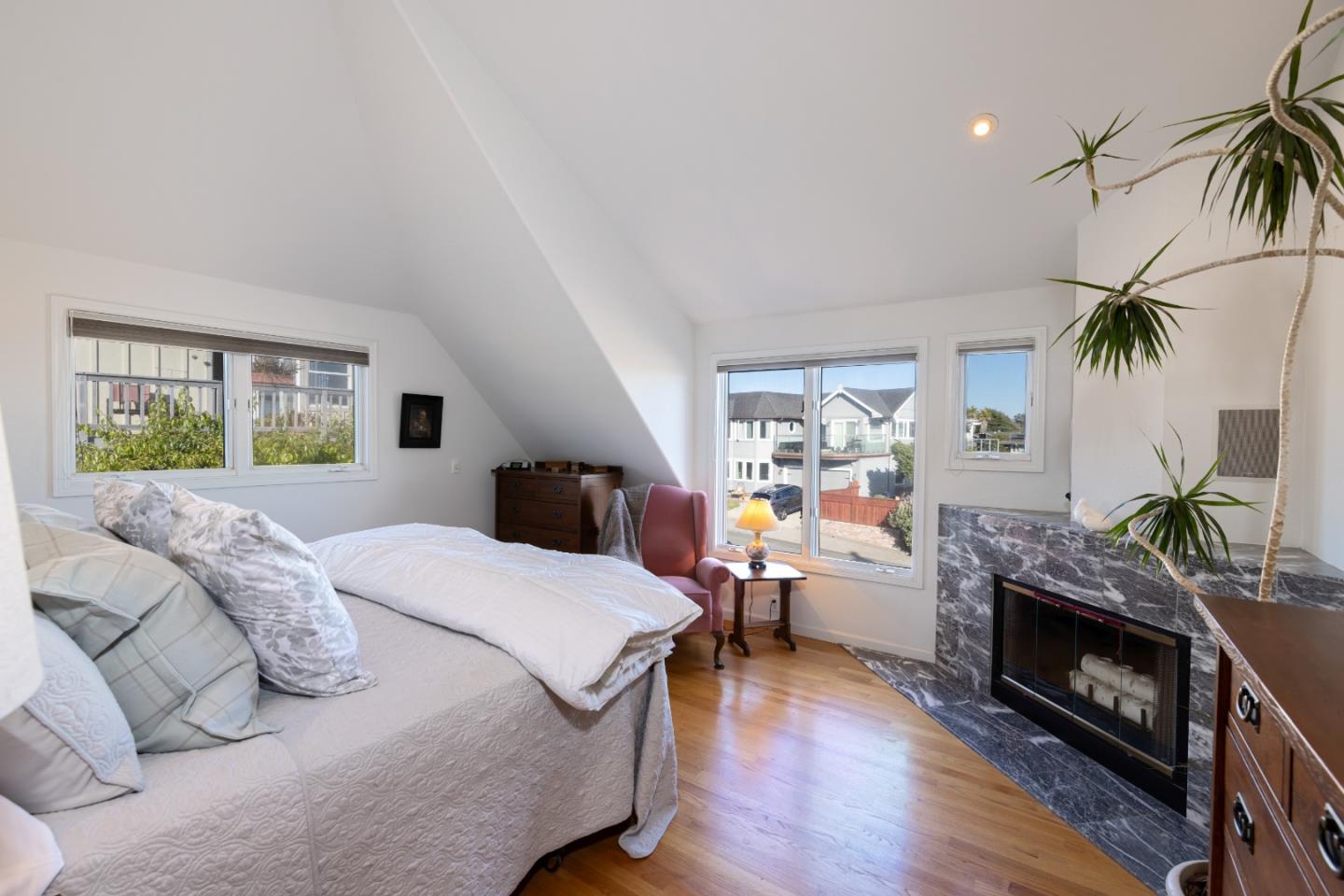 202 Seacliff Drive Aptos, CA 95003 - Photo 13 of 36 a bed room with furniture and a fireplace