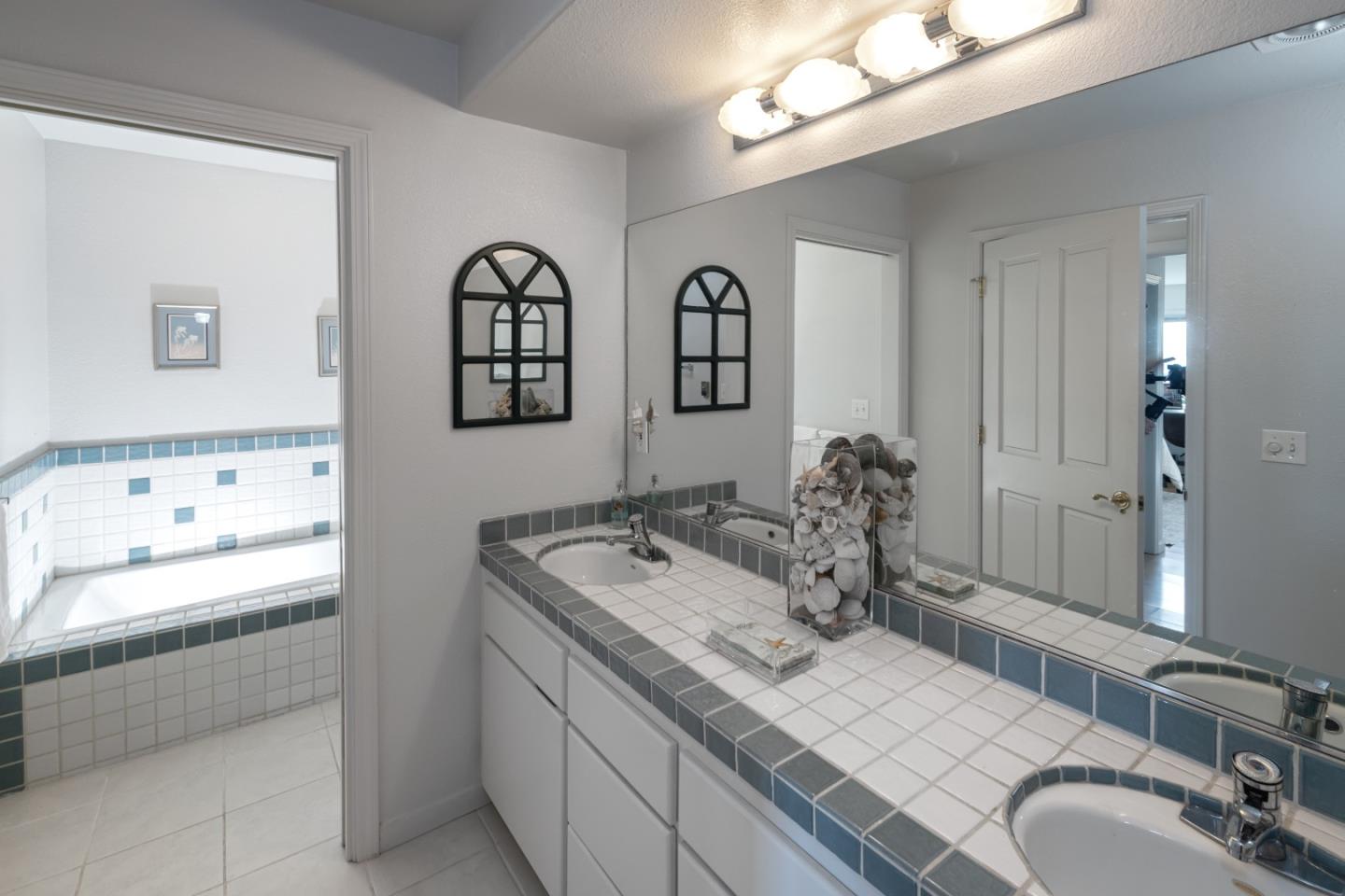 202 Seacliff Drive Aptos, CA 95003 - Photo 20 of 36 a bathroom with a granite countertop sink a mirror and shower