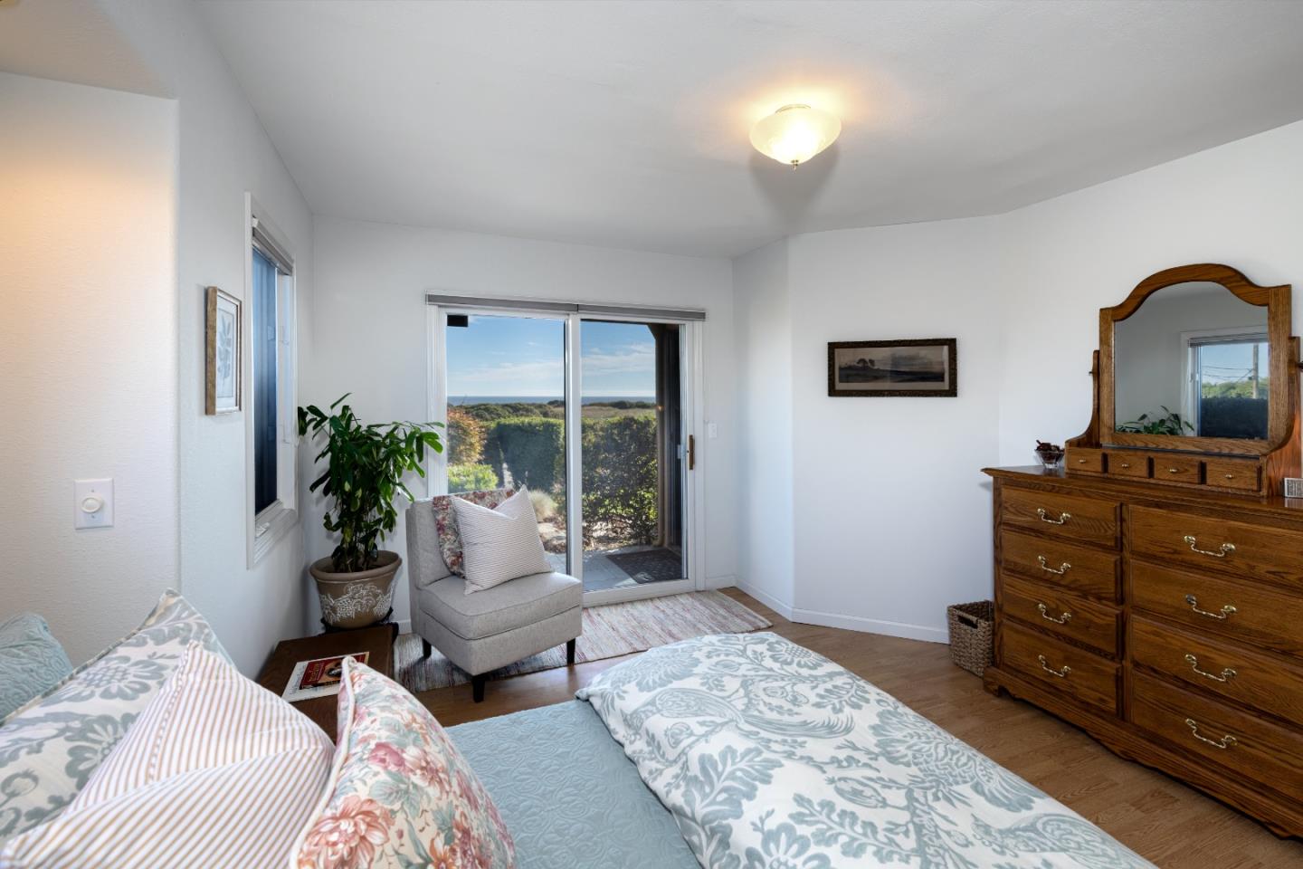 202 Seacliff Drive Aptos, CA 95003 - Photo 23 of 36 a bedroom with a bed and wooden floor