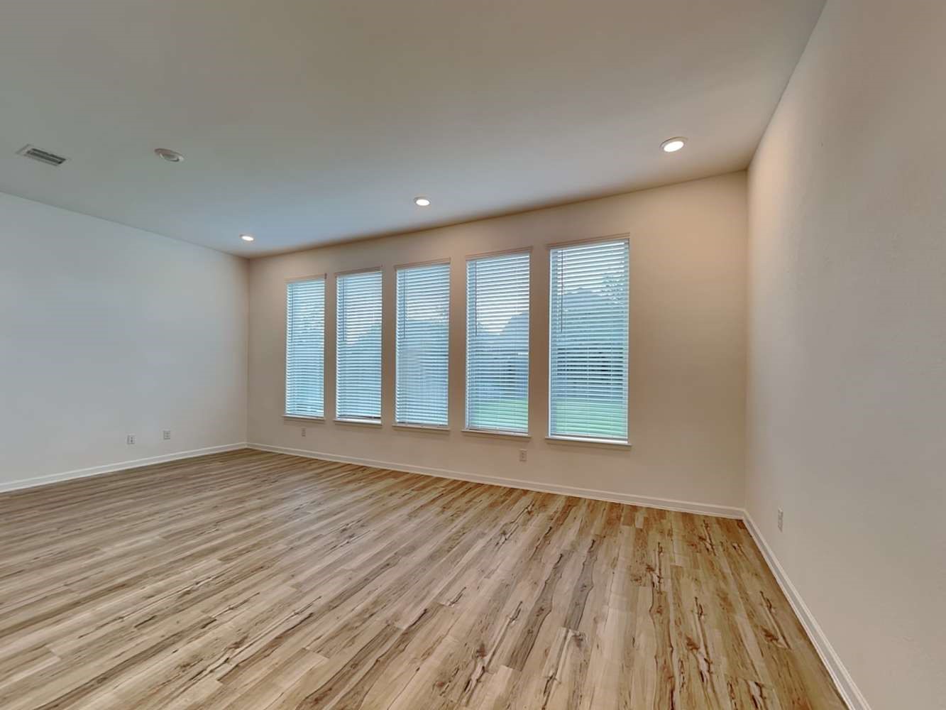 4023 Champlain Way Rosharon, TX 77583 - Photo 4 of 14 a view of an empty room with wooden floor and a window