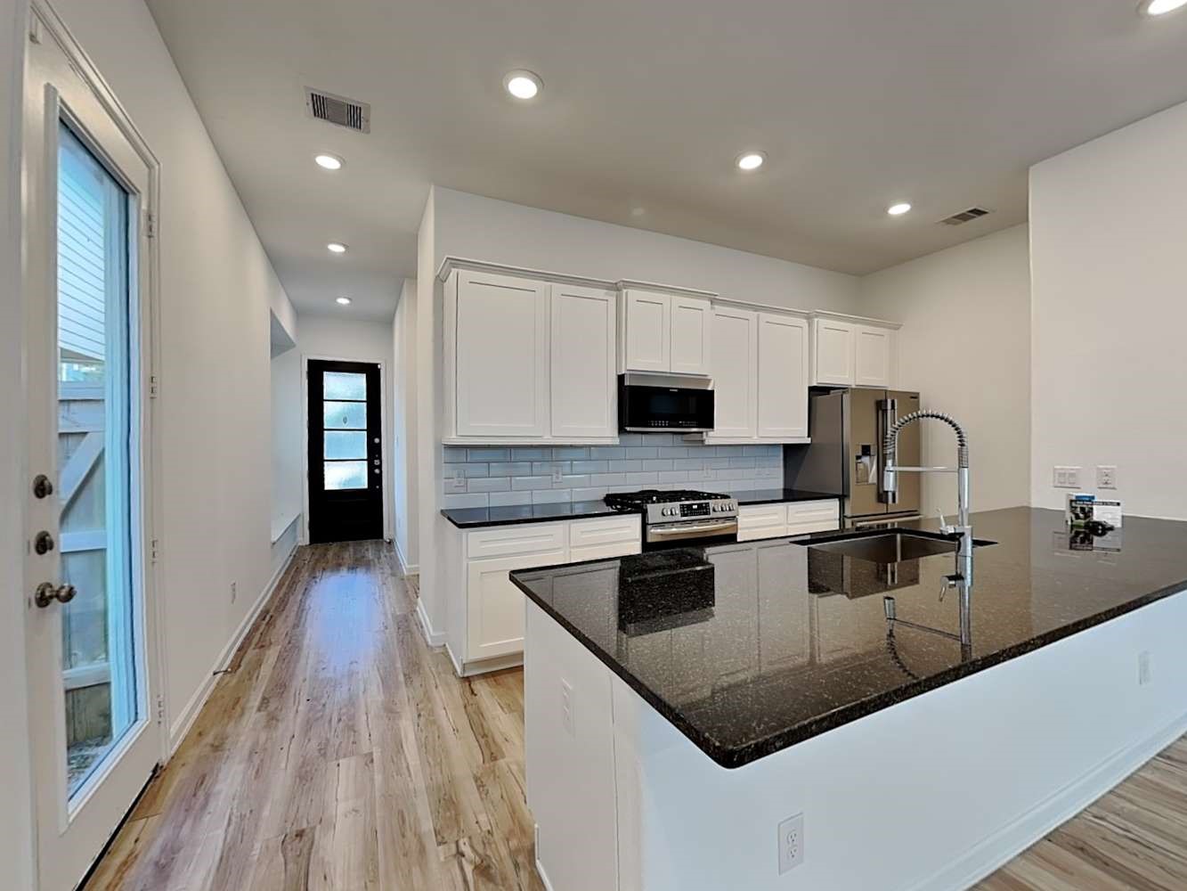 4023 Champlain Way Rosharon, TX 77583 - Photo 6 of 14 a kitchen with stainless steel appliances granite countertop a sink dishwasher stove top oven and refrigerator