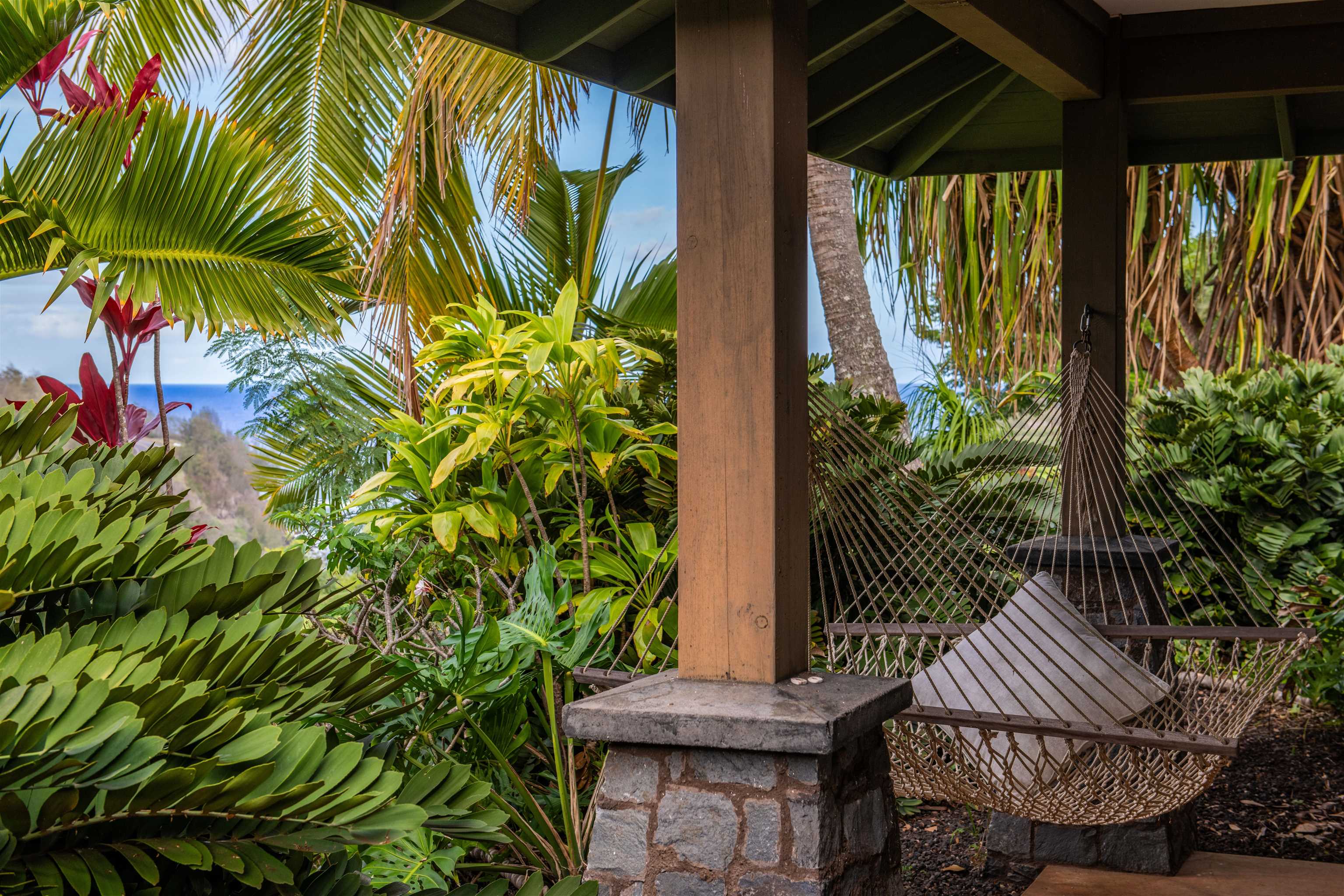 52 Papio Way, Unit A Haiku, HI 96708 - Photo 14 of 50 a view of a chair and table in the back yard of a house