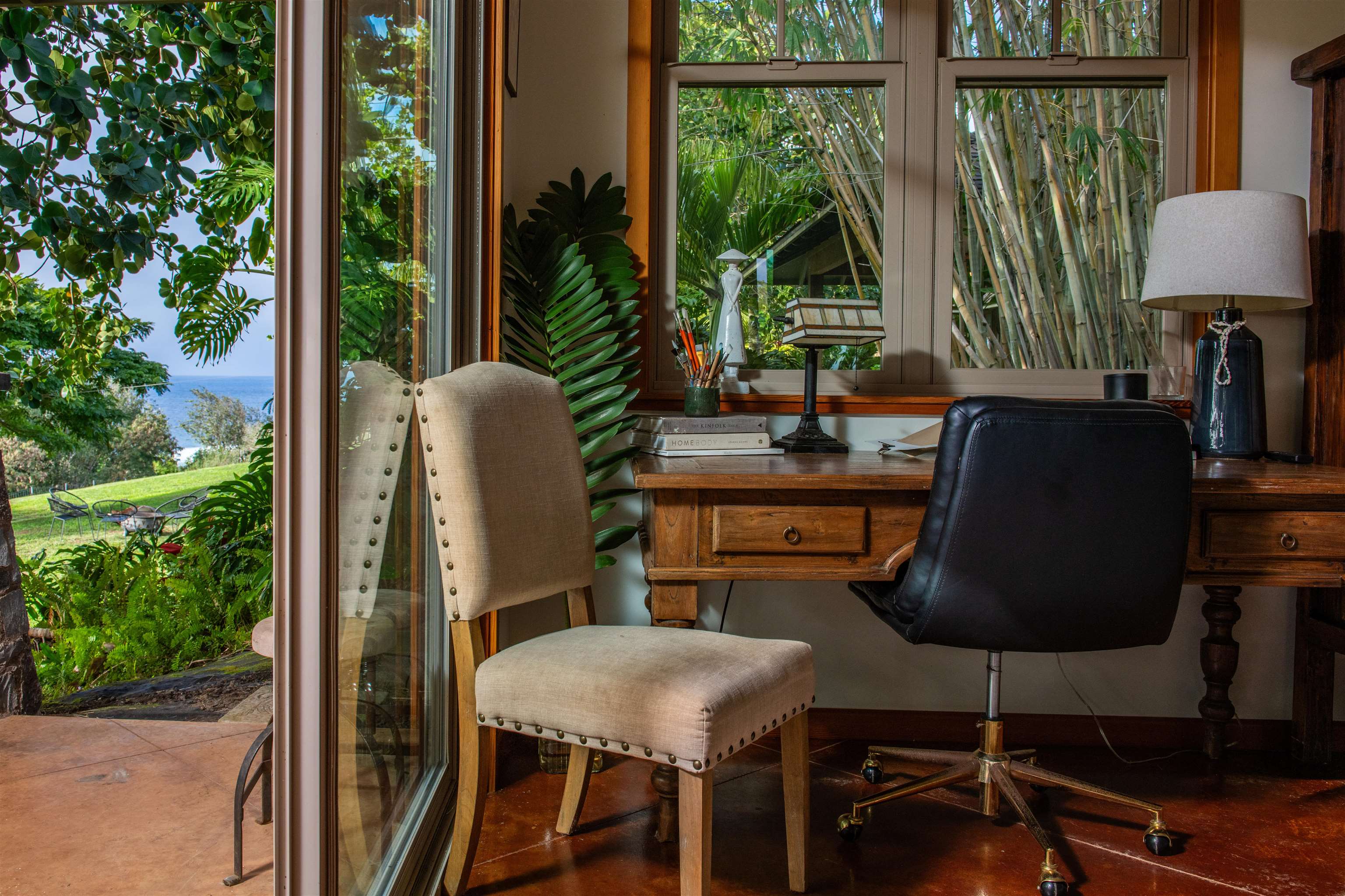 52 Papio Way, Unit A Haiku, HI 96708 - Photo 16 of 50 a dining room with furniture and a floor to ceiling window