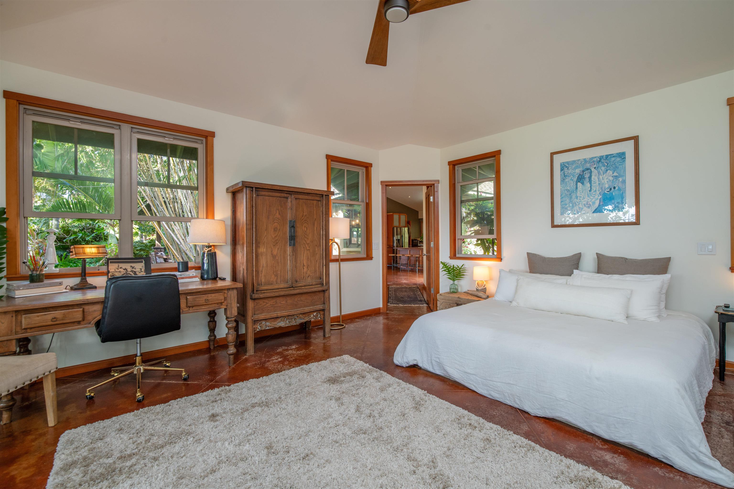 52 Papio Way, Unit A Haiku, HI 96708 - Photo 23 of 50 a bedroom with a bed a couch and large window