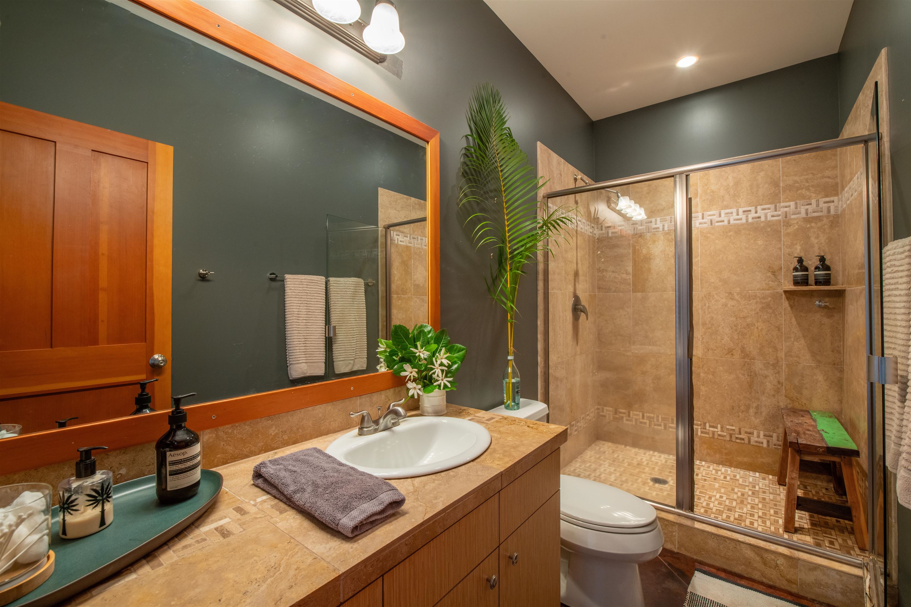 52 Papio Way, Unit A Haiku, HI 96708 - Photo 33 of 50 a bathroom with a granite countertop sink and a mirror