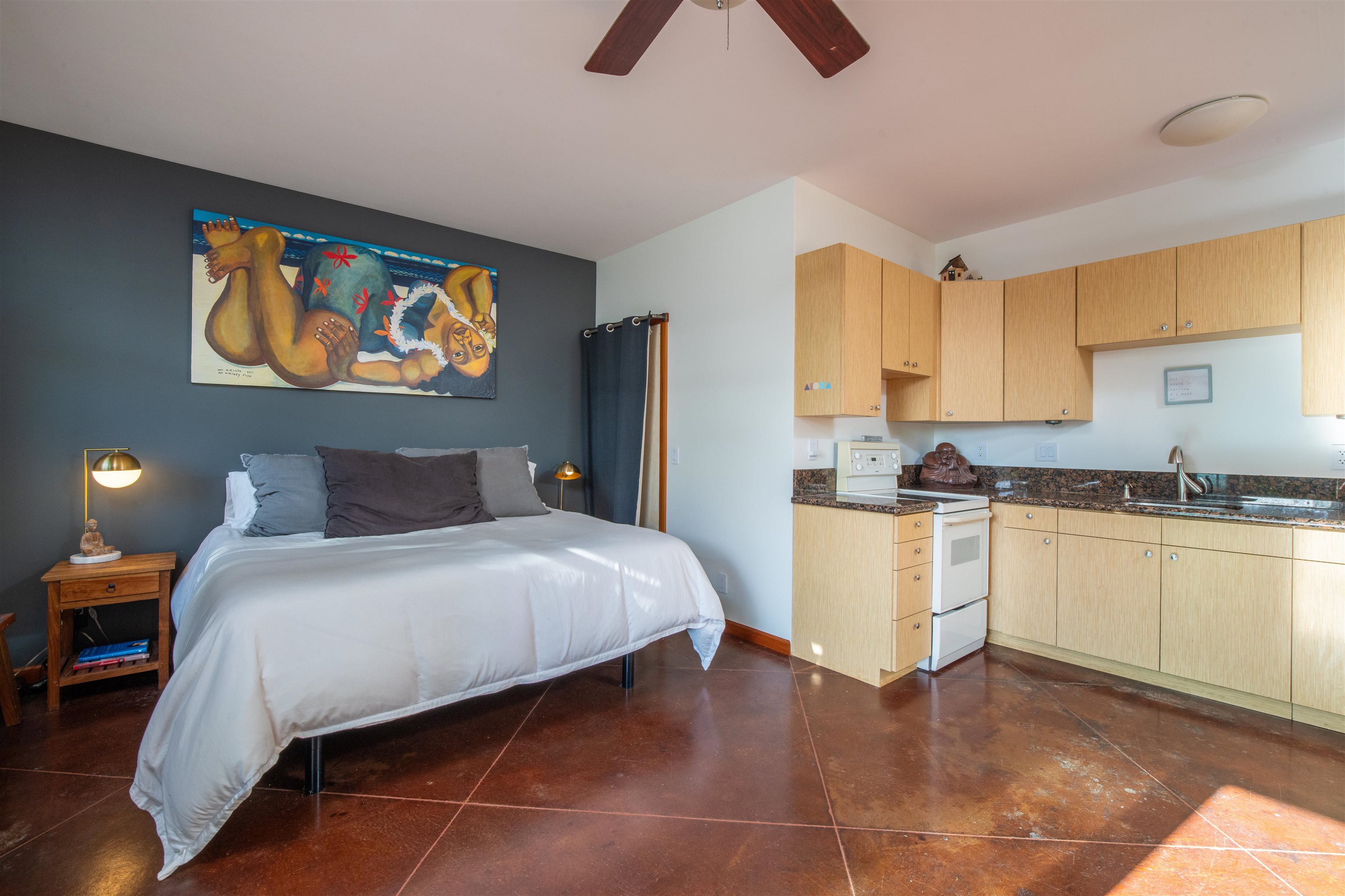 52 Papio Way, Unit A Haiku, HI 96708 - Photo 36 of 50 a bedroom with a bed and painting on the wall