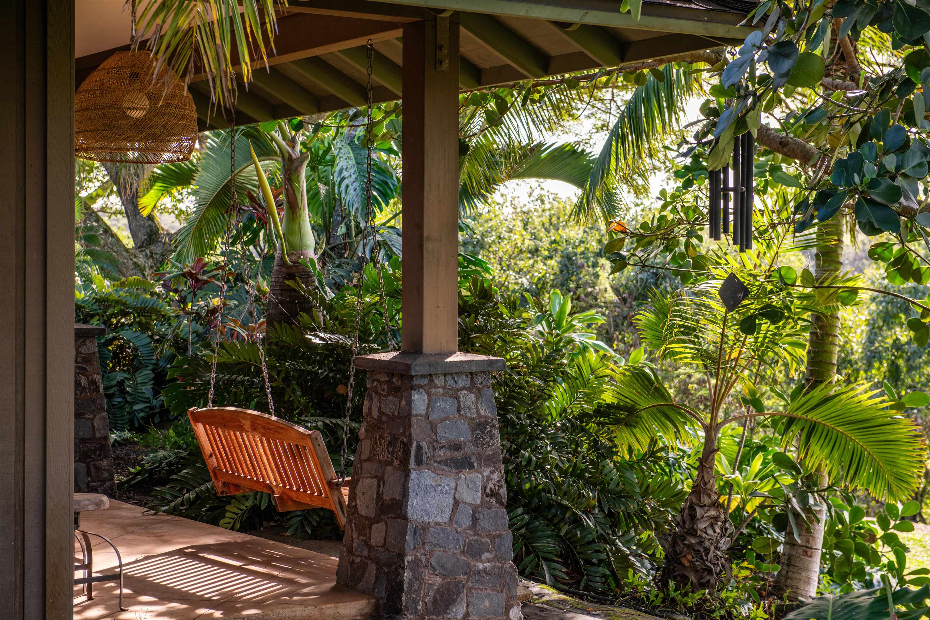 52 Papio Way, Unit A Haiku, HI 96708 - Photo 43 of 50 a backyard of a house with table and chairs under an umbrella
