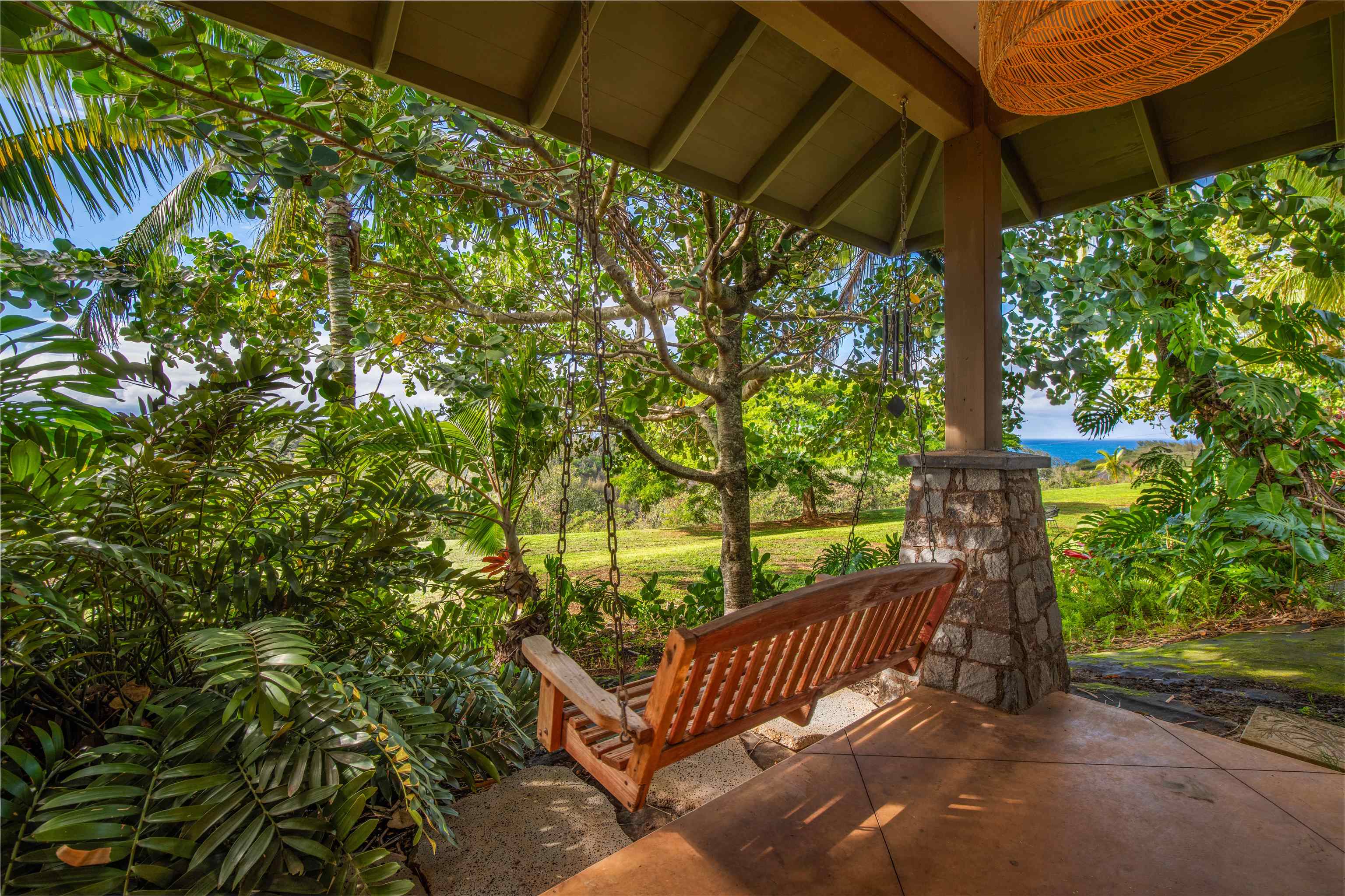 52 Papio Way, Unit A Haiku, HI 96708 - Photo 9 of 50 a view of a roof deck with table and chairs under an umbrella with a small yard