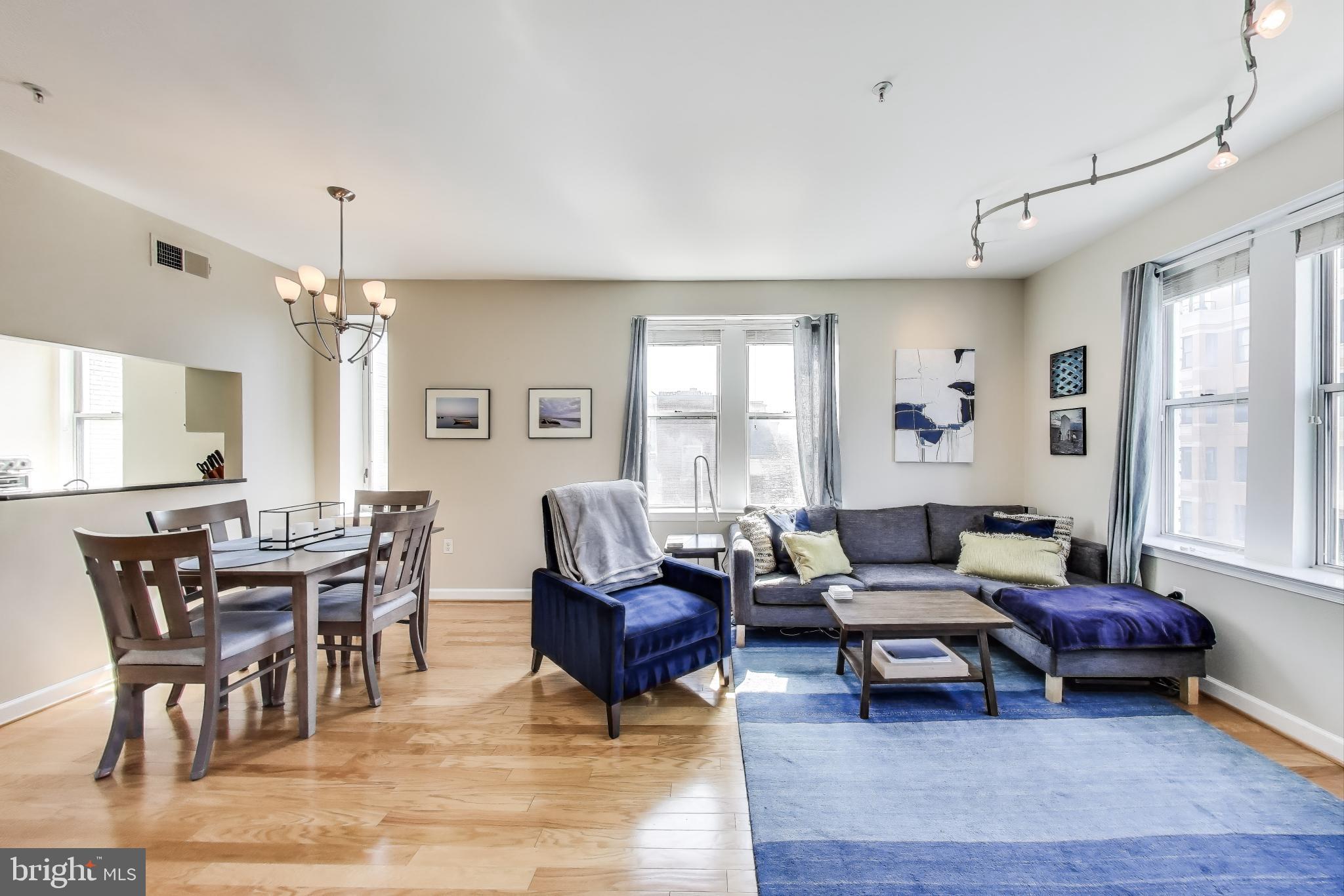 1619 R Street Northwest, Unit 501 Washington, DC 20009 - Photo 11 of 25 a living room with furniture and a chandelier