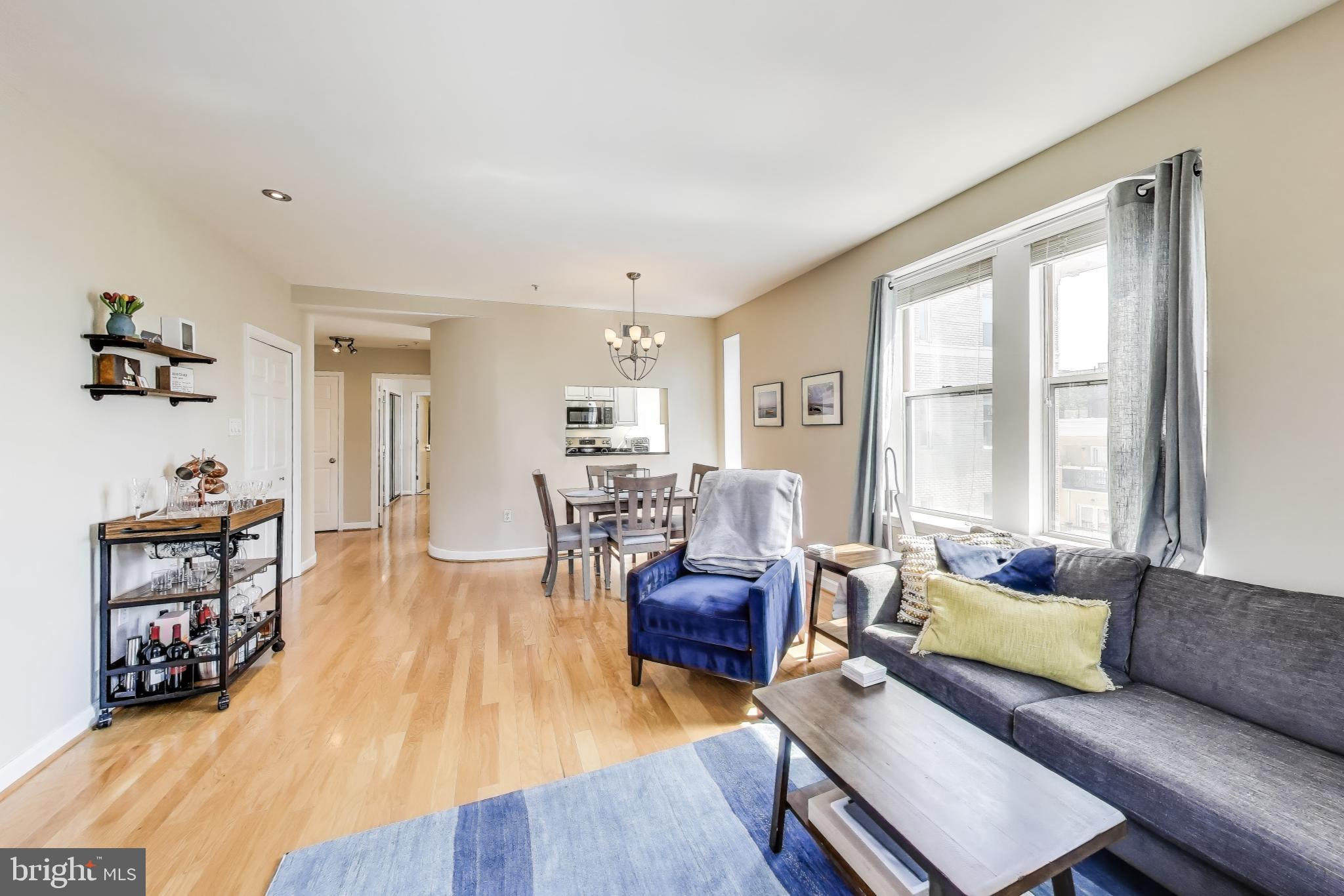 1619 R Street Northwest, Unit 501 Washington, DC 20009 - Photo 12 of 25 a living room with furniture and a wooden floor