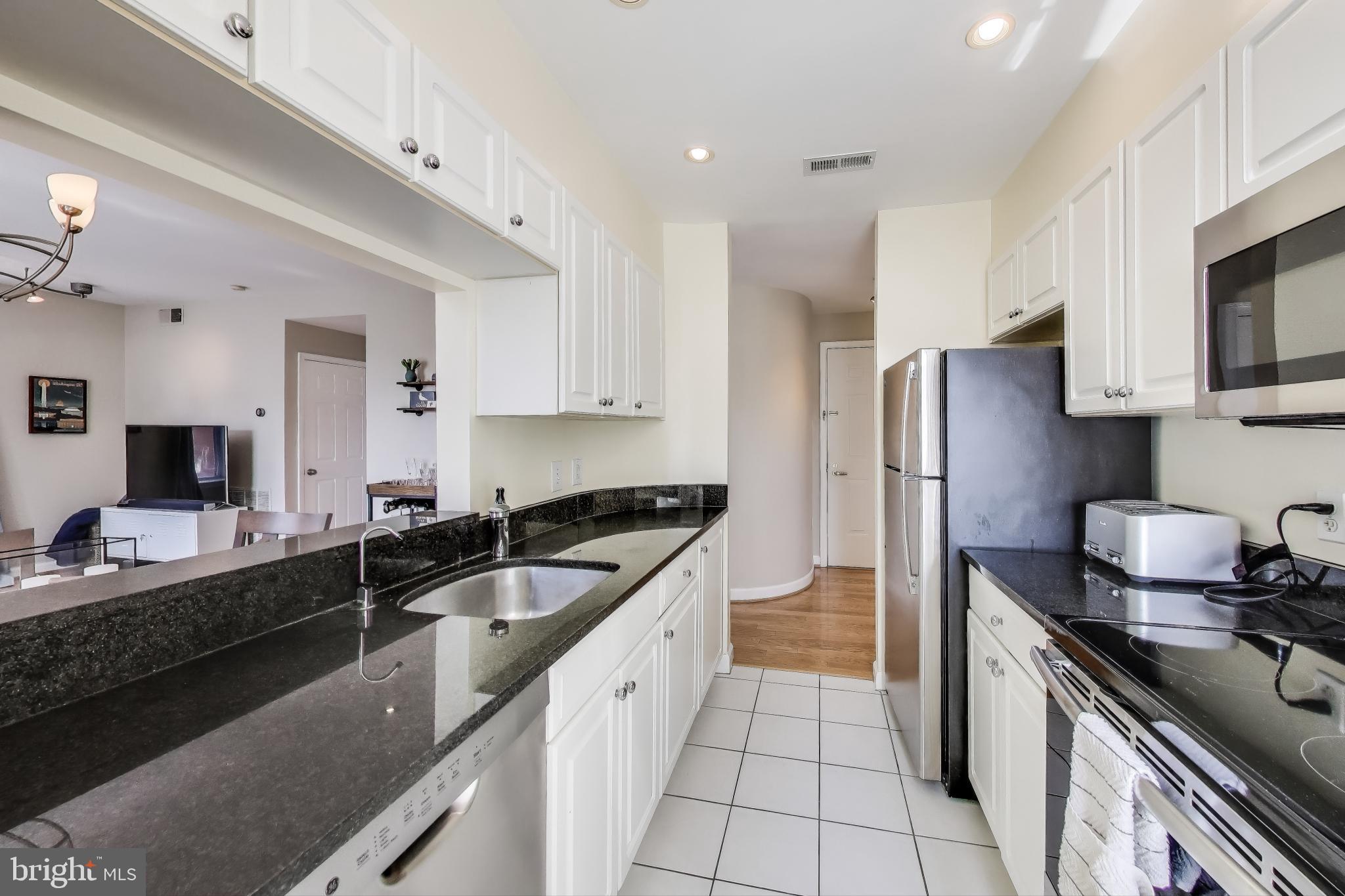 1619 R Street Northwest, Unit 501 Washington, DC 20009 - Photo 15 of 25 a kitchen with a sink stove and refrigerator