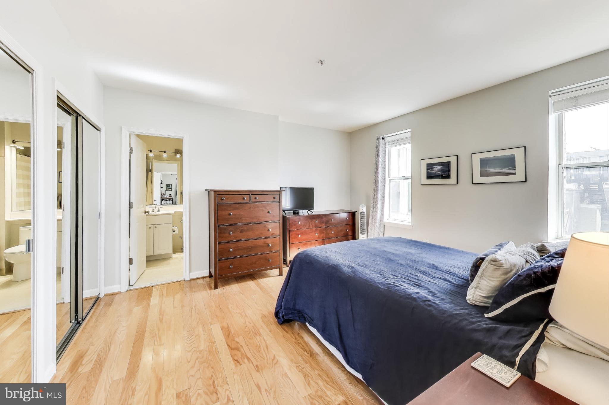 1619 R Street Northwest, Unit 501 Washington, DC 20009 - Photo 16 of 25 a bedroom with a bed and dresser with mirror