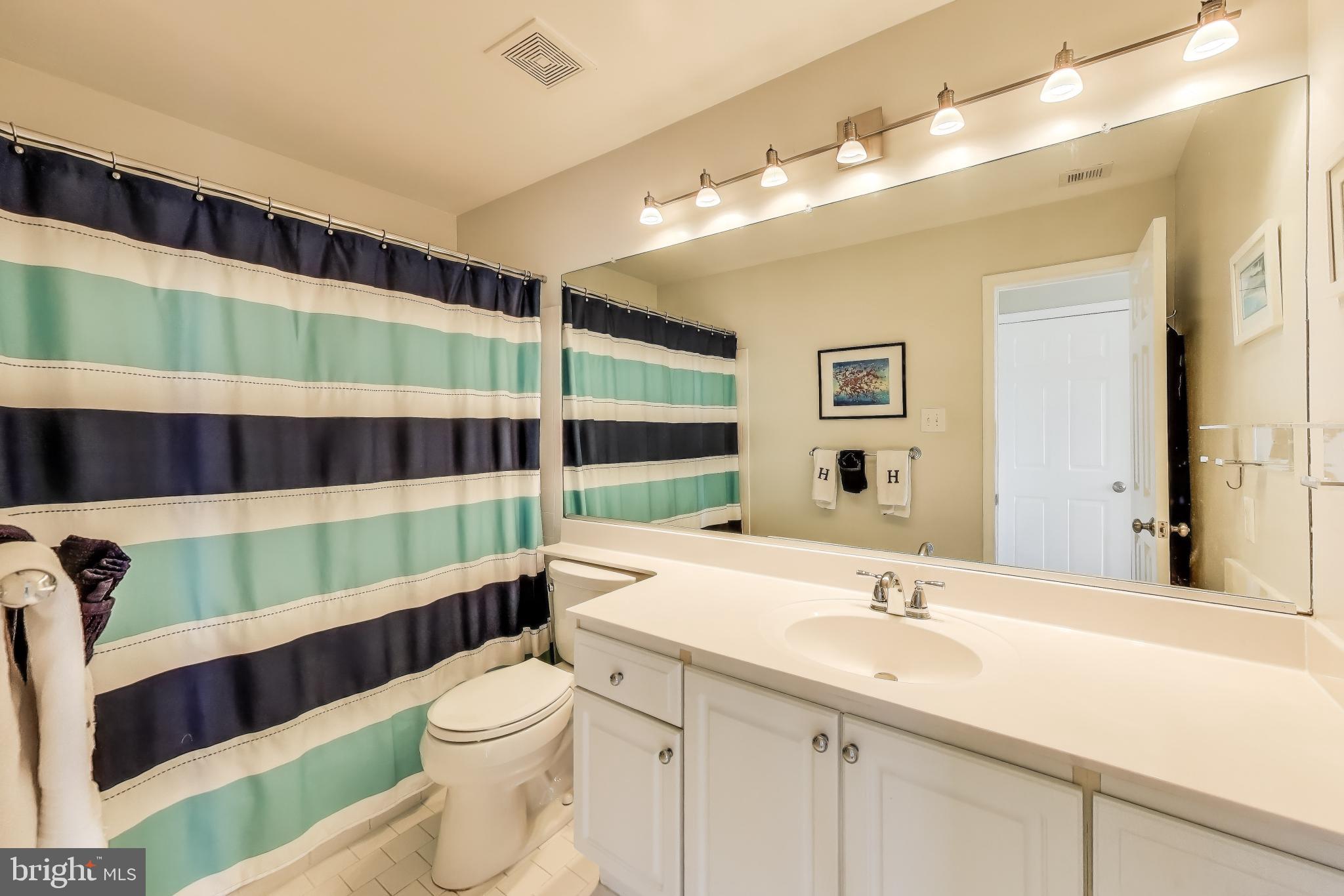1619 R Street Northwest, Unit 501 Washington, DC 20009 - Photo 23 of 25 a bathroom with a sink and a large mirror