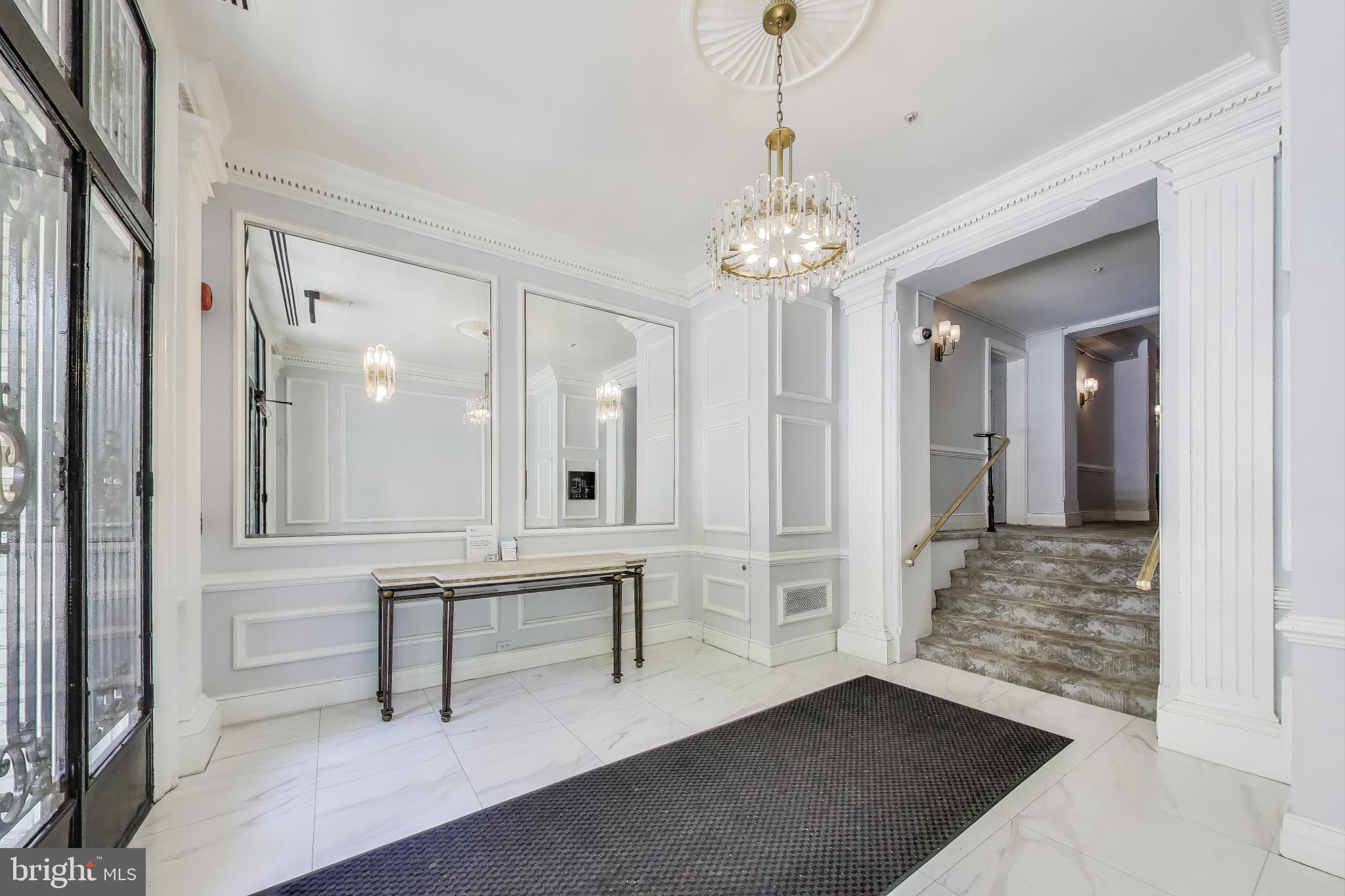 1619 R Street Northwest, Unit 501 Washington, DC 20009 - Photo 6 of 25 a view of a hallway with wooden floor and chandelier