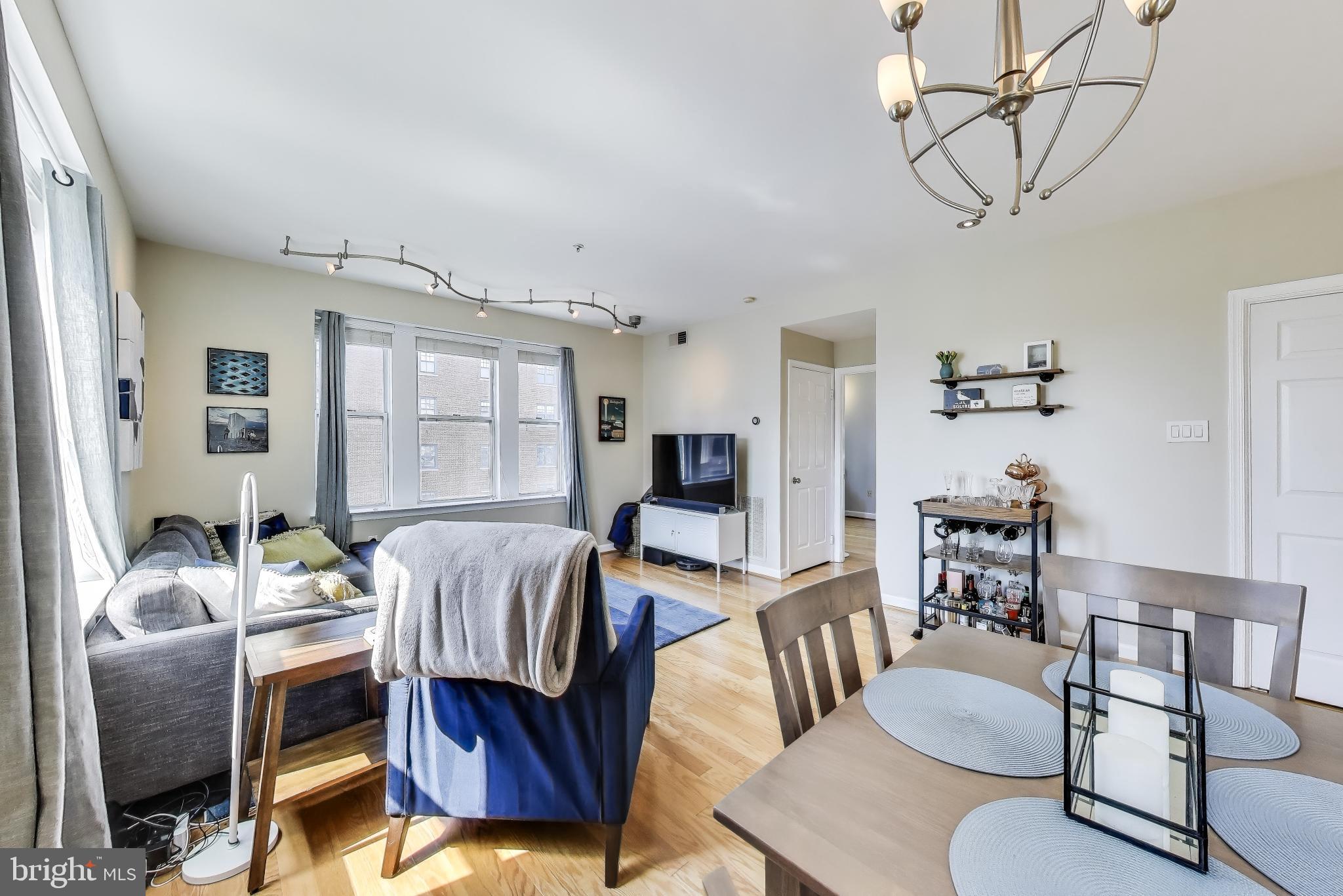 1619 R Street Northwest, Unit 501 Washington, DC 20009 - Photo 10 of 25 a living room with furniture and wooden floor