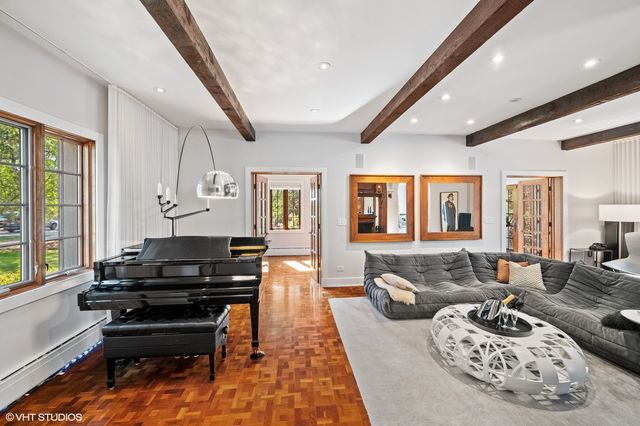a living room with furniture and a piano