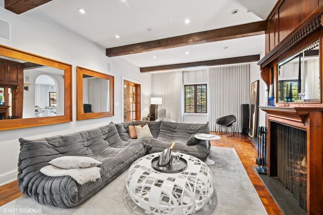 a living room with furniture fireplace and a large window