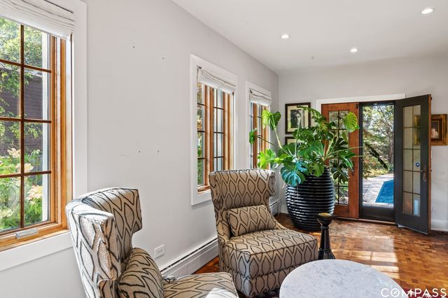 a living room with furniture and a floor to ceiling window