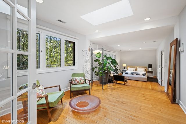 a view of a dining room with furniture a rug and wooden floor