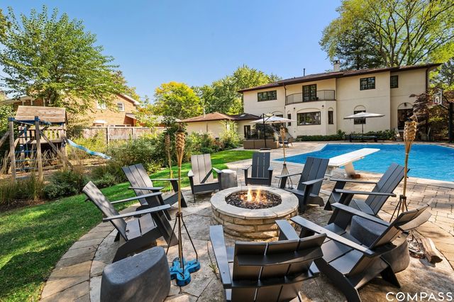 a view of a patio with table and chairs potted plants and a palm tree