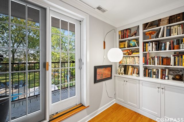 a living room with fish tank and a bookshelf