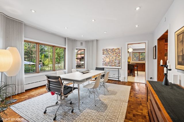 a dining room with wooden floor and window