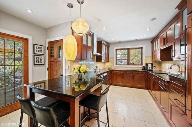 a kitchen that has a table and chairs in it