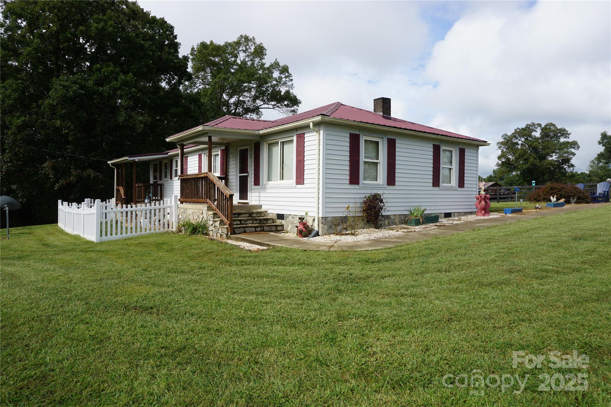 4744 Hickory Nut Ridge Road Hudson, NC 28638 - Photo 17 of 35 a front view of a house with a yard