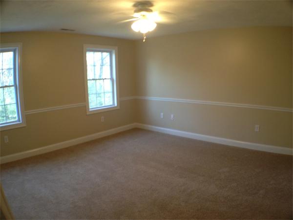 60 Tenney Road Westford, MA 01886 - Photo 23 of 27 en empty room with windows and chandelier fan