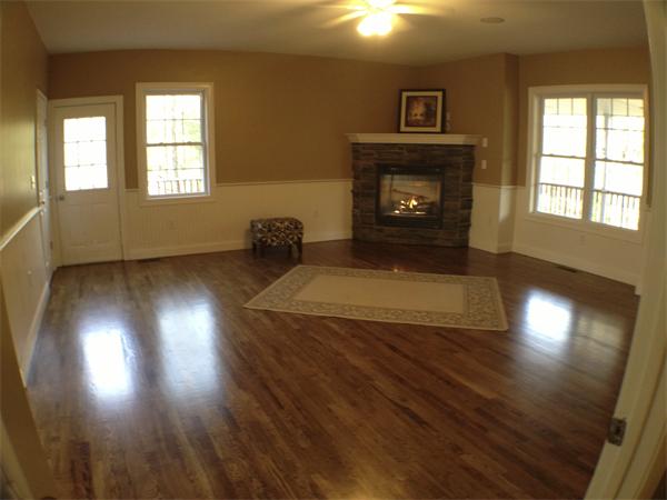 60 Tenney Road Westford, MA 01886 - Photo 24 of 27 an empty room with wooden floor fireplace and windows