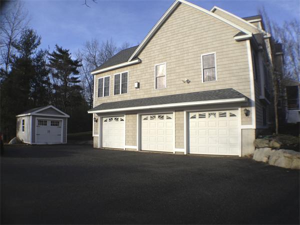 60 Tenney Road Westford, MA 01886 - Photo 3 of 27 a front view of a house with a garage